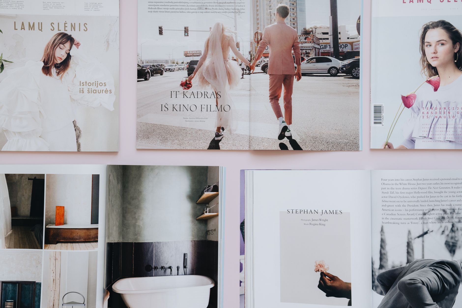 Open magazine spreads laid out on a table